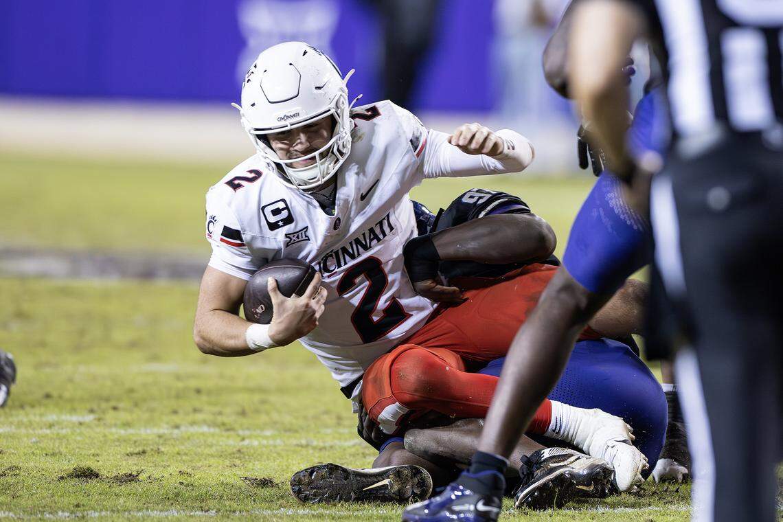 TCU defensive end Paul Oyewale (97) sacks Cincinnati quarterback Brendan Sorsby (2) in the second half of a Big XII conference game between the TCU Horned Frogs and the Cincinnati Bearcats at Amon G Carter Stadium in Fort Worth on Saturday, Nov. 29, 2025.