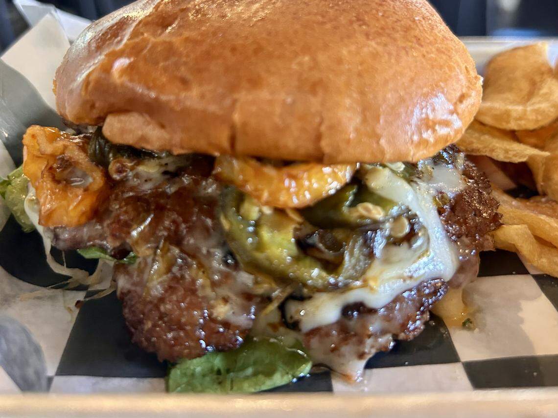 The Spicy smashburger with ghost-pepper jack cheese, fried peppers, grilled jalapeños, lettuce, onion and habanero mayo is a regular menu item at The Bearded Lady pub and tavern in Fort Worth.