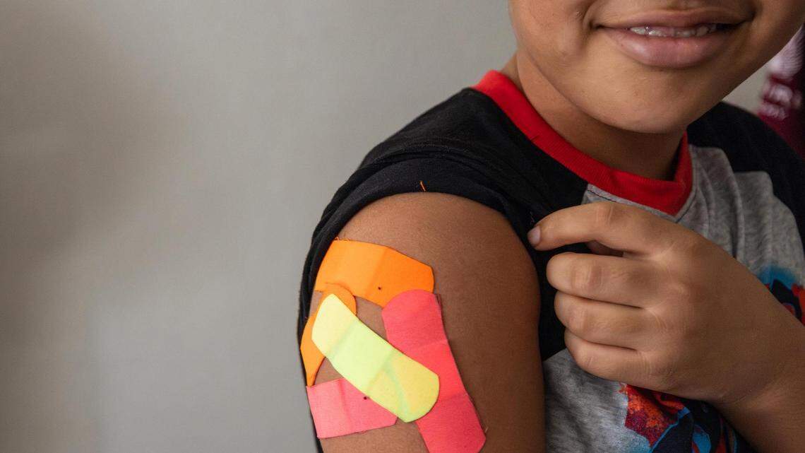 Omar Wahidi, 12, shows the bandaids from vaccines given to him in his right arm. State health officials have declared the measles outbreak in West Texas over.