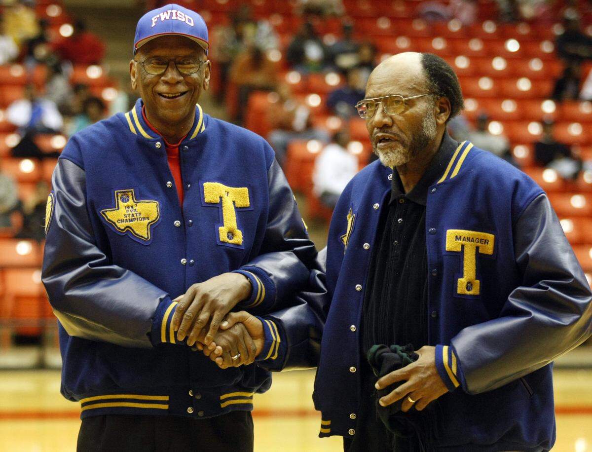In this photo from 2009, John Gales and Allen Tillman greet each other on the court as they are honored with their 1957 I.M. Terrell Prairieview Interscholastic League Championship teammates at halftime during the Dunbar vs Eastern Hills High School Boys Basketball game at Wilkerson-Greines Activity Center in Fort Worth.