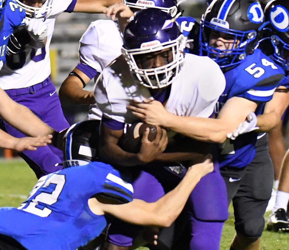 Alvarado’s Kameron Webb, center, is tackled by Decatur’s Bryce Shetter, left and Max Downe during a punt return in the fourth quarter of their Friday’s September 4, 2020 Football game in Decatur, Texas. Special/Bob Haynes