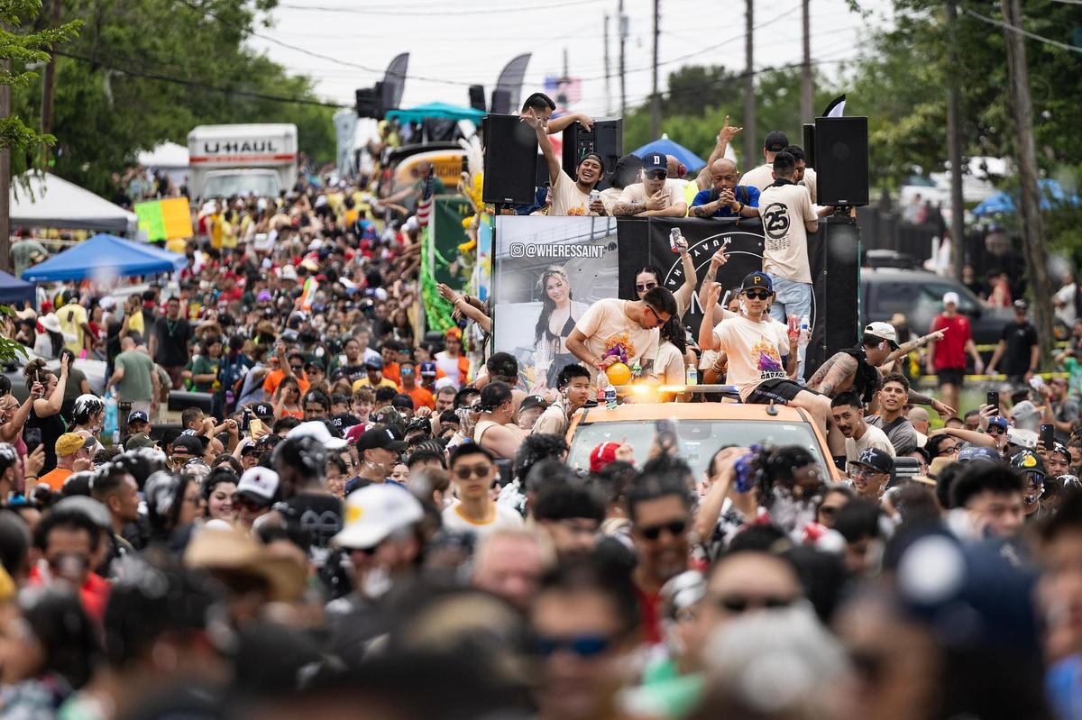 Tens of thousands of festival attendees flock the streets for the Lao New Year parade on the third day of the Lao New Year festival at Wat Lao Thepnimith Temple in Saginaw on Sunday, April 27, 2025.