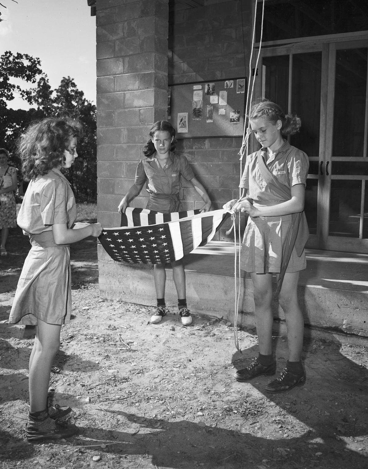 April 15, 1945: Girl Scouts Martha Ann Emery, left, and Patsy Ruth Crowley. Martha Ann is a Brownie scout for Troop 9 and Patsy an intermediate scout of Troop 52. They make the rounds of their neighborhood in the Girl Scout cookie sale.