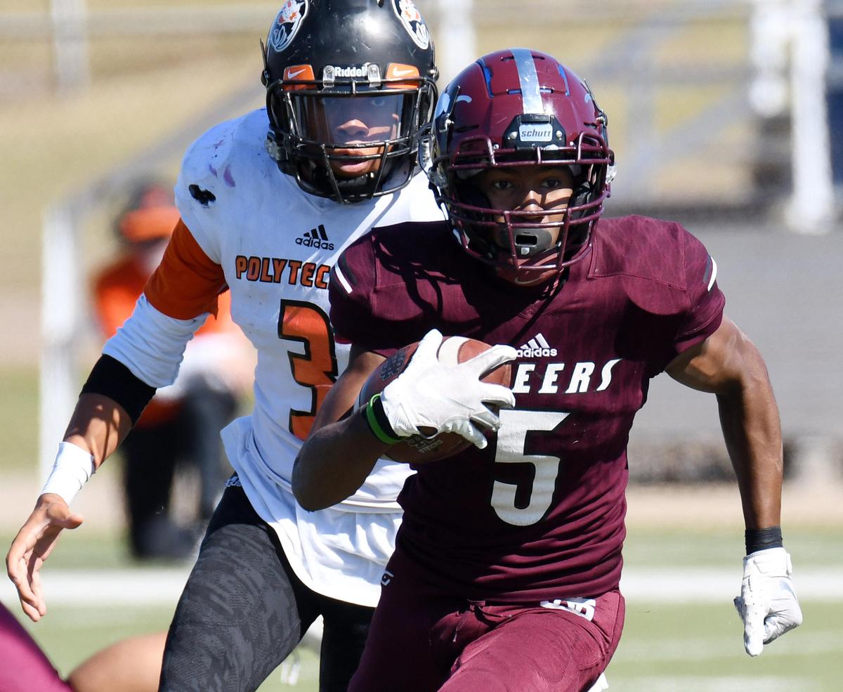 Polytechnic’s Akeil Smiley, left chaes North Side’s Da’Wain Lofton as he races for a first dwon in the fourth quarter during Saturday’s November 2, 2019 football game at Scarborough-Handley Field in Fort Worth, Texas. North Side went on to win 21-20. Special/Bob Haynes