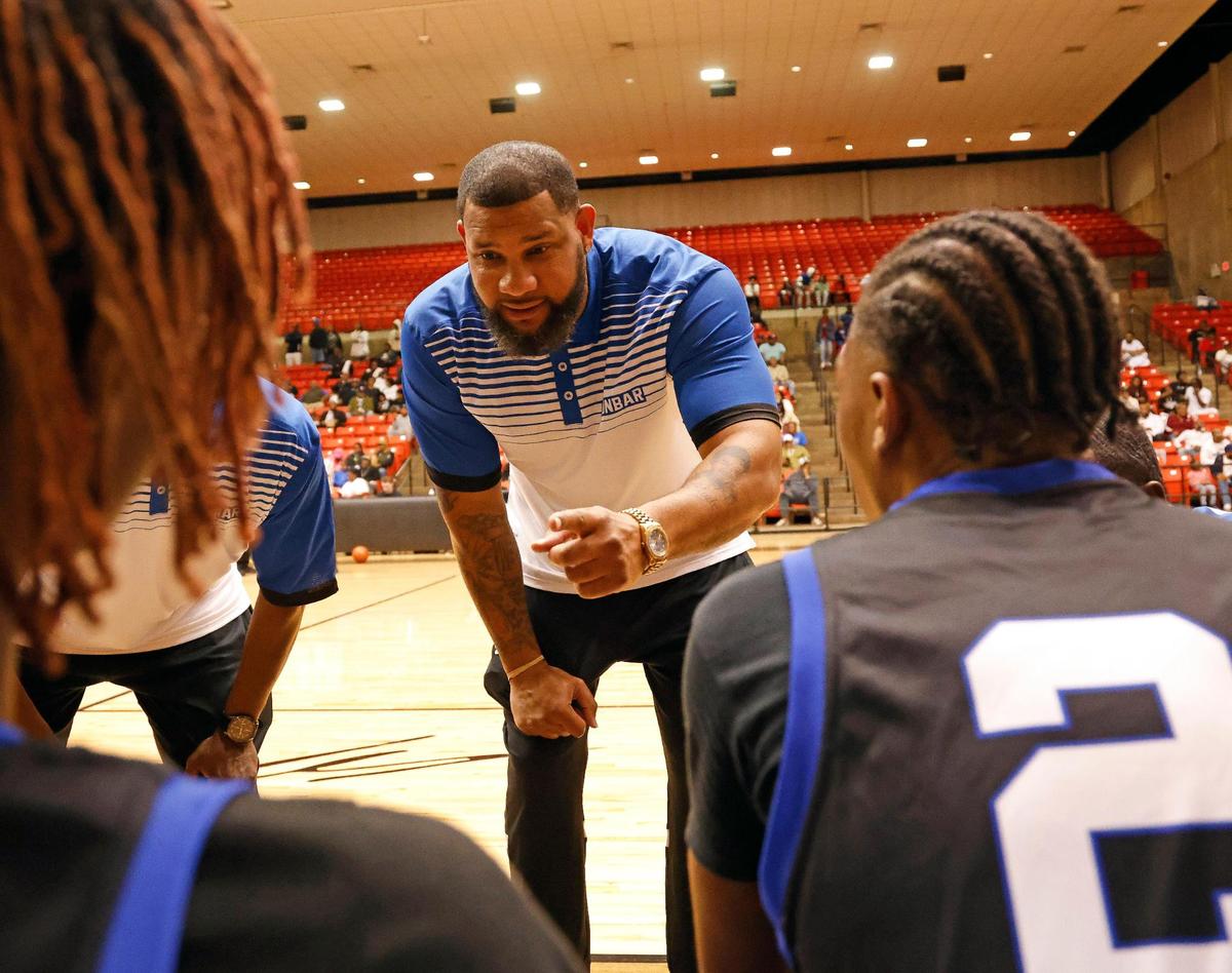 Dunbar head coach Swarn Lacy talks to the bench during a time out in the third quarter of a high school basketball game at Wilkerson Greines Activity Center in Fort Worth, Texas, Saturday, Jan, 27, 2024.