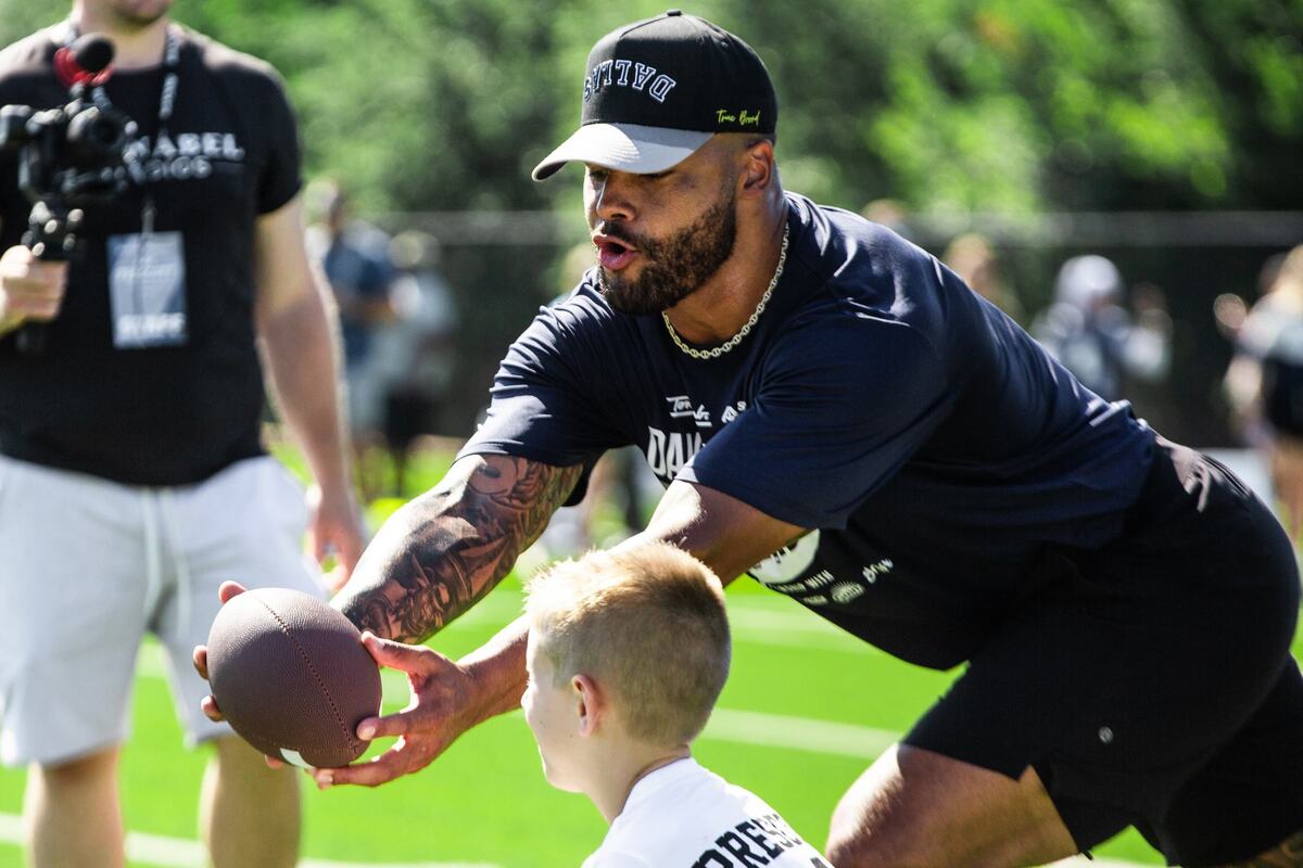 Dallas Cowboys quarterback Dak Prescott catches the ball during youth football pro camp on Tuesday July 9 at Carroll senior high school southlake practice field. Prescott made an appearance at the camp to show kids the fundamentals of football.