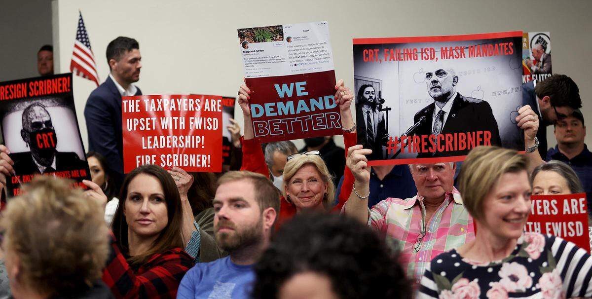 In this December 2021 file photo, parents and community members concerned about CRT continuing to be taught in schools attend a Fort Worth ISD school board meeting.