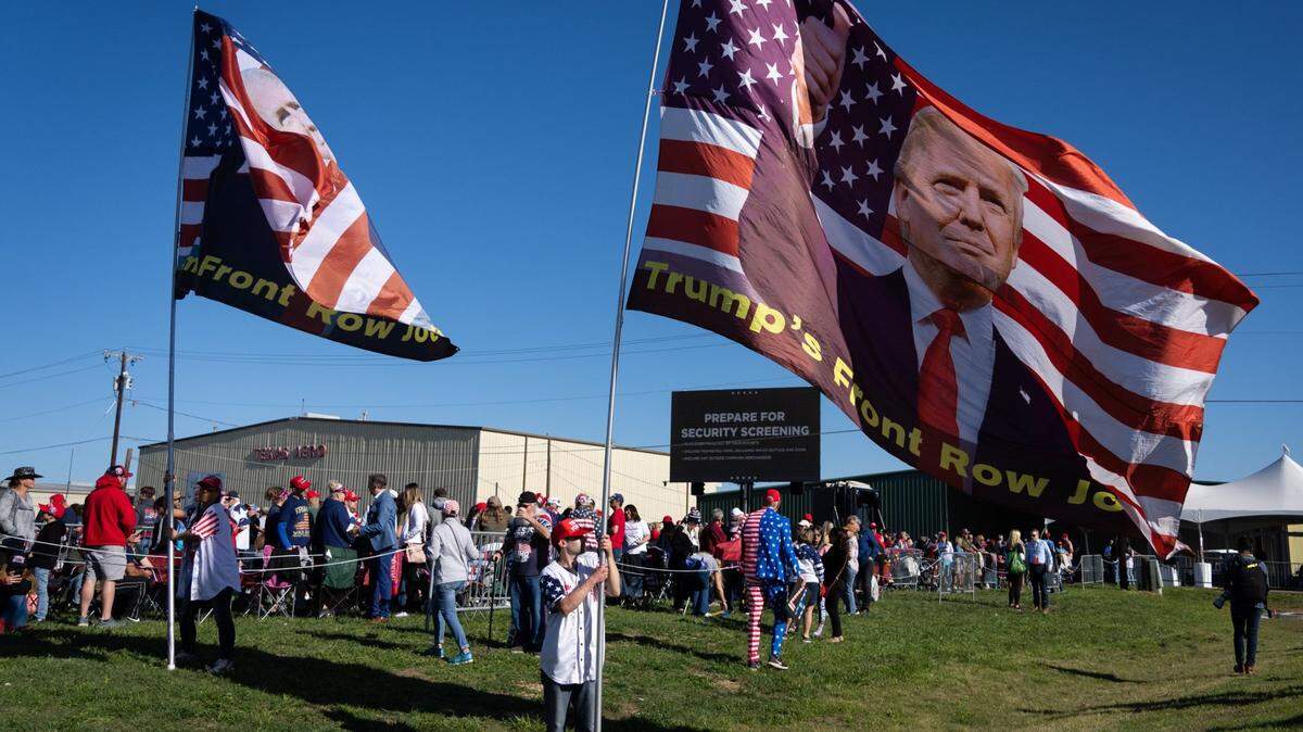 Adam Radogna, from Ohio, holds a large flag while waiting to enter former President Donald Trump’s rally Saturday in Waco. Radogna travels to many of Trump’s rallies as part of a group called “The Front Row Joes.” (Sara Diggins-USA TODAY NETWORK)
