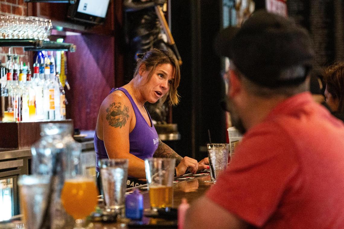 Bartender Taylor Turman speaks with costumers sitting in the bar at the Flying Saucer in downtown Fort Worth on Monday, July 29, 2024.