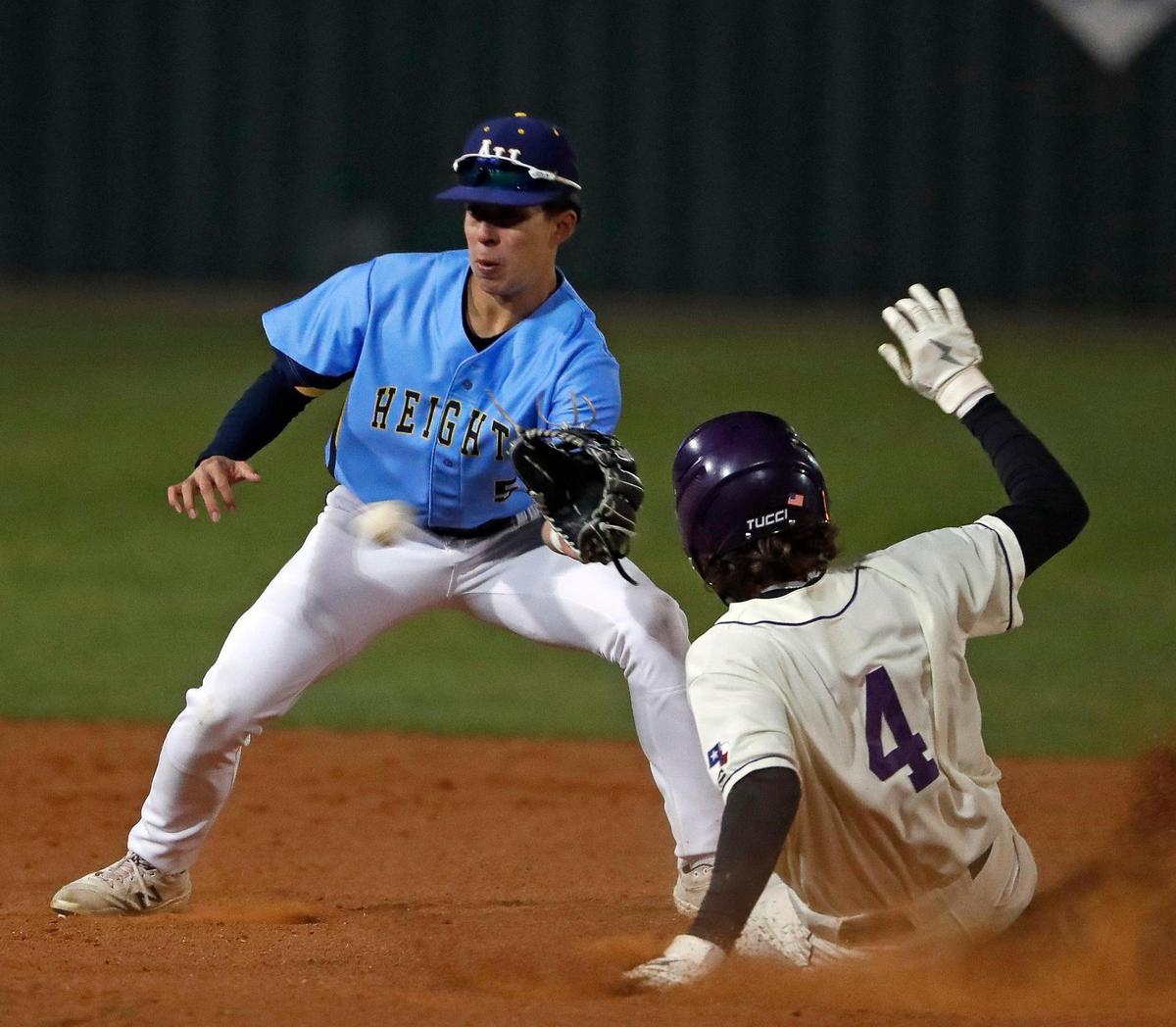 Paschal infielder Julian Minor (4) beats the throw to Arlington Heights infielder Javi Alvarez (5) at second during the Drew Medford Baseball Tournament at Paschal High School in Fort Worth, Texas, Saturday, Mar. 12, 2022. Paschal defeated Arlington Heights 7-4 on nine hits and no errors. (Special to the Star-Telegram Bob Booth)