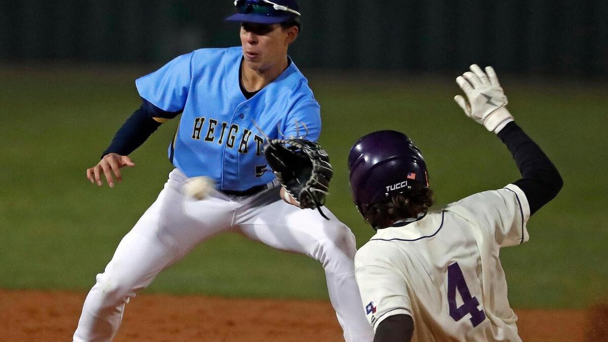 Paschal infielder Julian Minor (4) beats the throw to Arlington Heights infielder Javi Alvarez (5) at second during the Drew Medford Baseball Tournament at Paschal High School in Fort Worth, Texas, Saturday, Mar. 12, 2022. Paschal defeated Arlington Heights 7-4 on nine hits and no errors. (Special to the Star-Telegram Bob Booth)