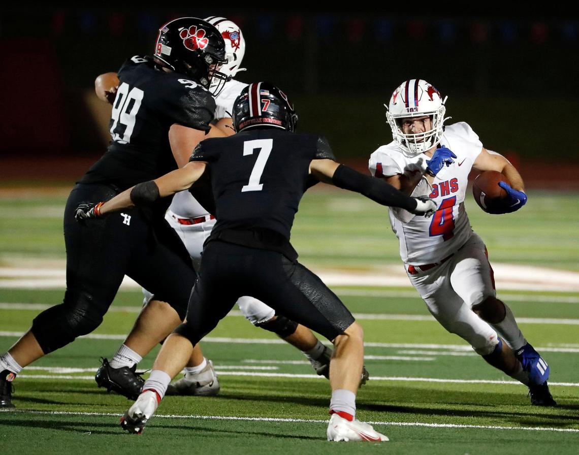 Grapevine athlete Parker Polk (4) hits the hole defended by Heritage defensive back Jack Sluder (7) in the second half of a high school football game at Mustang-Panther Stadium in Grapevine Texas, Friday, Sept. 30, 2022. Grapevine defeated Colleyville Heritage 44-26 for The Battle of the Red Rail. (Special to the Star-Telegram Bob Booth)