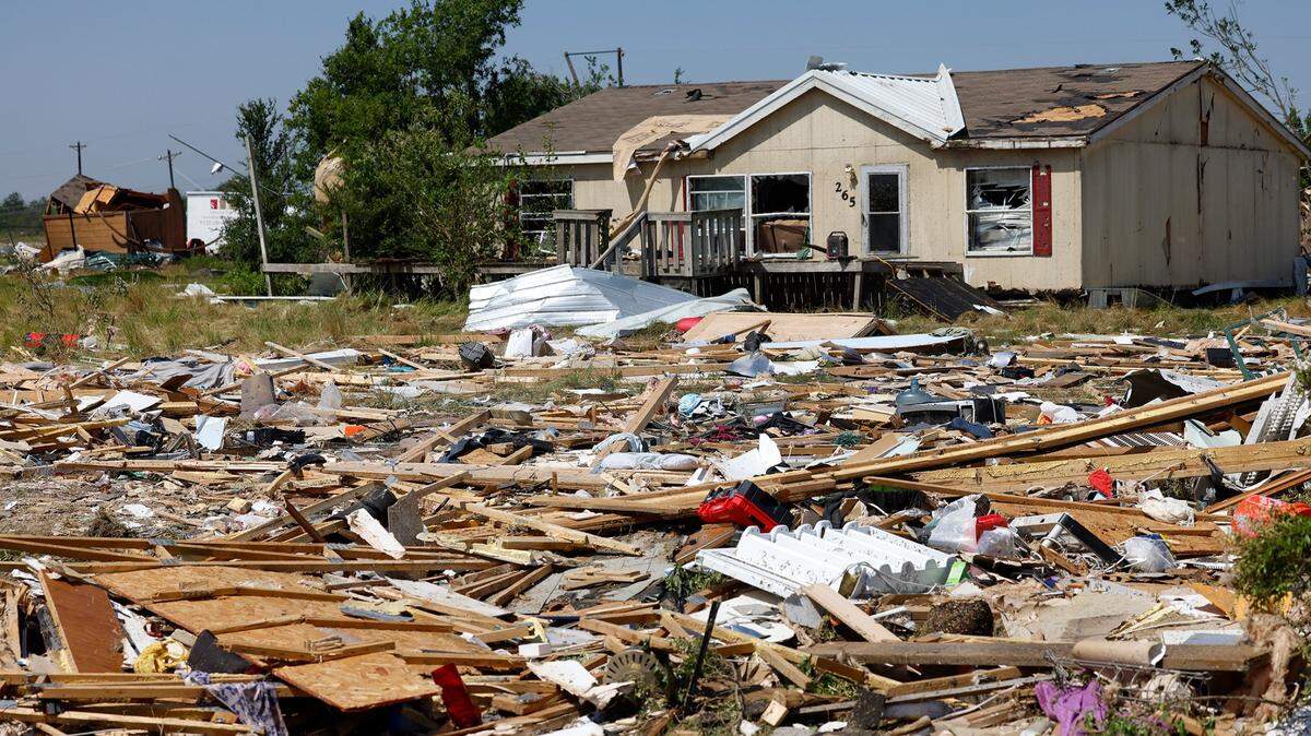 Debris surrounds a home in Valley View on Sunday, May 26, 2024, after severe storms moved through Denton and Cooke counties. With tornado season underway, it’s important to know the best way to protect your family and pets from damage.