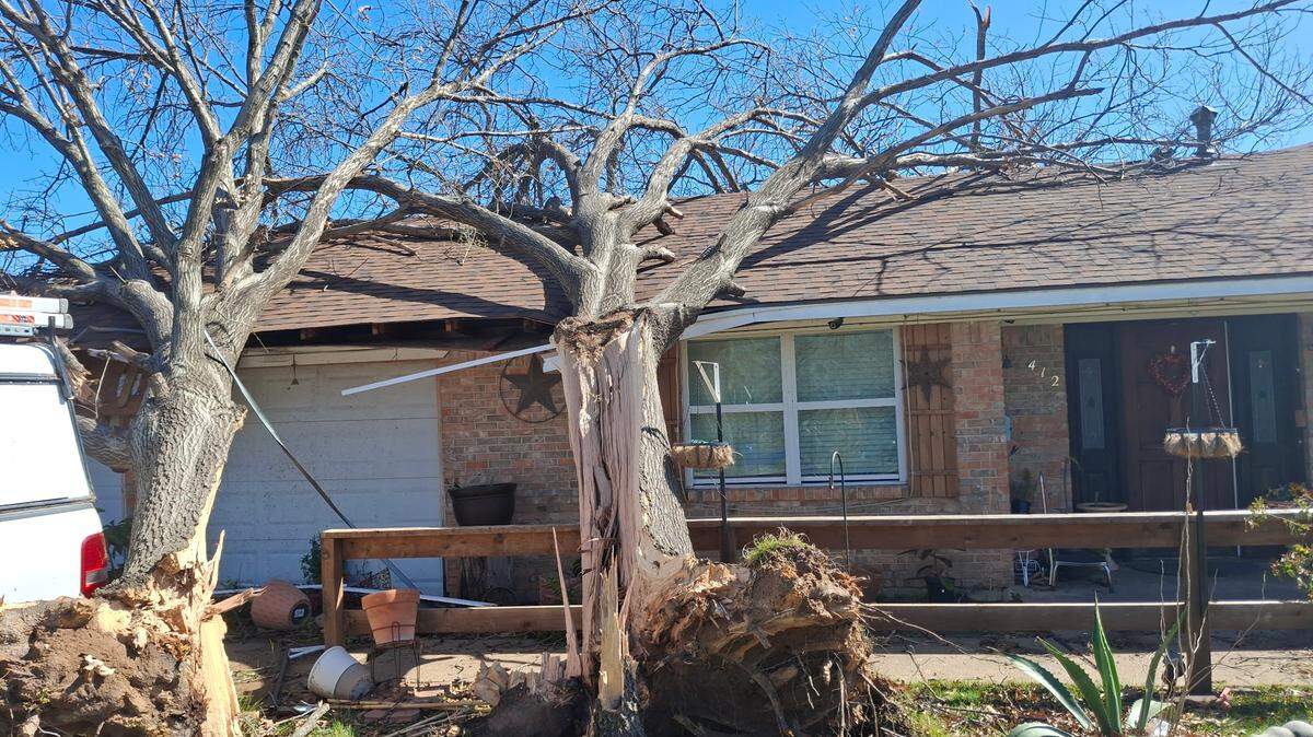 A tree fell on Eugenio Ruiz’s house in Irving on Tuesday, March 4. He said the wind and rain were so bad he couldn’t see anything outside for a while.
