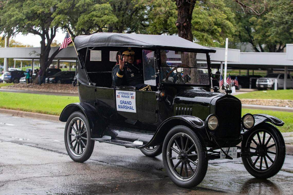 The parade’s grand marshal, Maj. Gen. Anthony Woods, commander of the Texas State Guard, waves to a crowd gathered to watch the Veterans Day Parade in Fort Worth on Friday, Nov. 11, 2022. Despite rain, hundreds of participants marched down North Forest Park Boulevard, waving American flags and signing a medley of military songs.