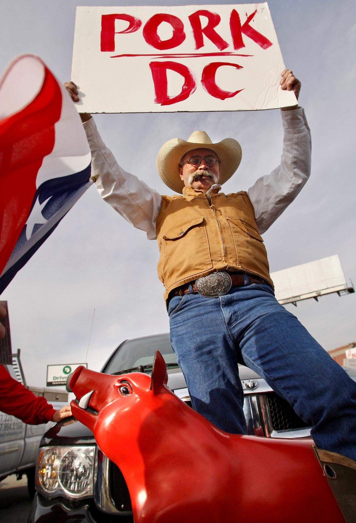 John Cowan of Argyle, Texas, stands atop a motorized pig and joins other protesters angry over recent government bailouts at the inaugural Fort Worth tea party rally outside Cowtown Bar & Grill on Camp Bowie Boulevard West on Feb. 27, 2009.