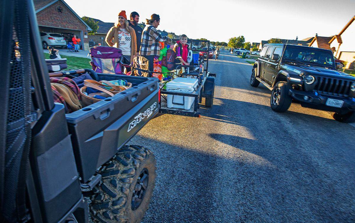 A large all-terrain vehicle pulled a makeshift float of Halloween revelers at Main Place, an Acton residential subdivision, Tuesday, Oct. 31, 2023.
