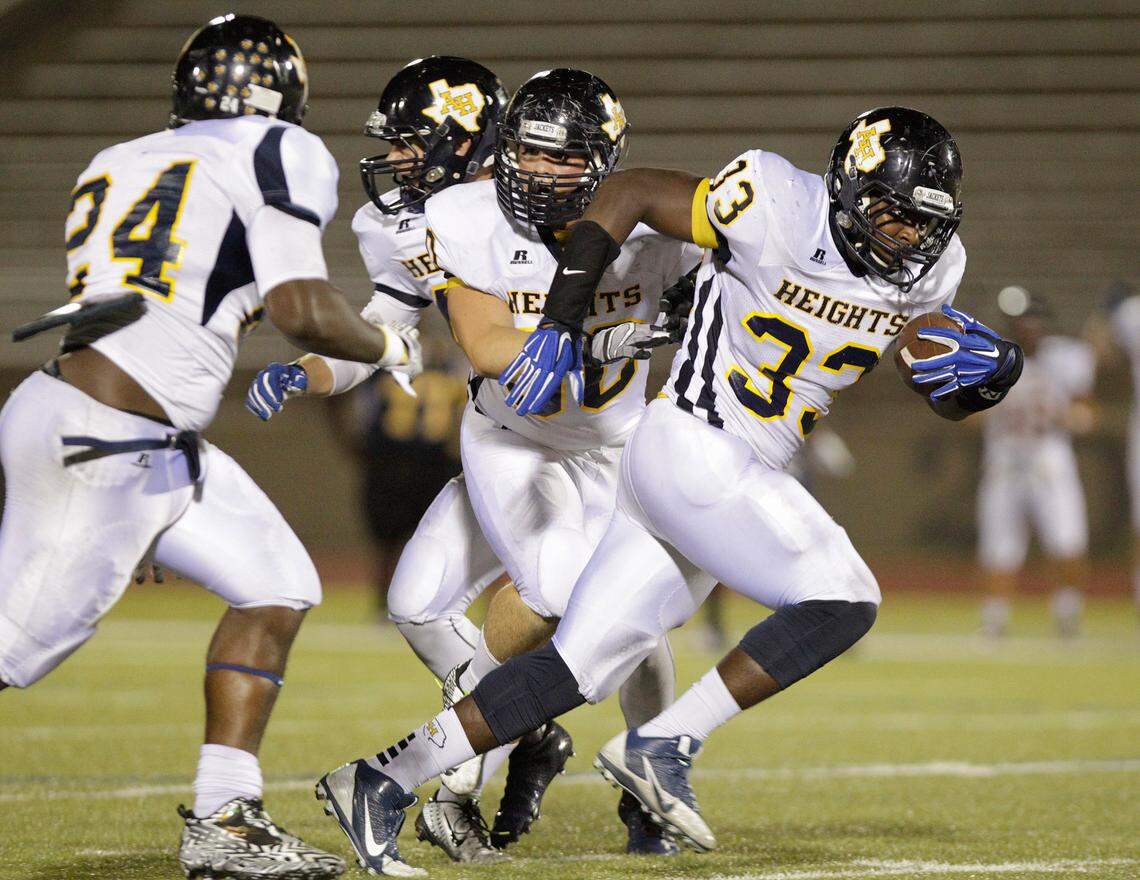 Corban James, right, of Arlington Heights returns a fumble by O.D. Wyatt quarterback Jacoby Cloud late in the second quarter in Fort Worth, TX Thursday, Oct. 9, 2014.
