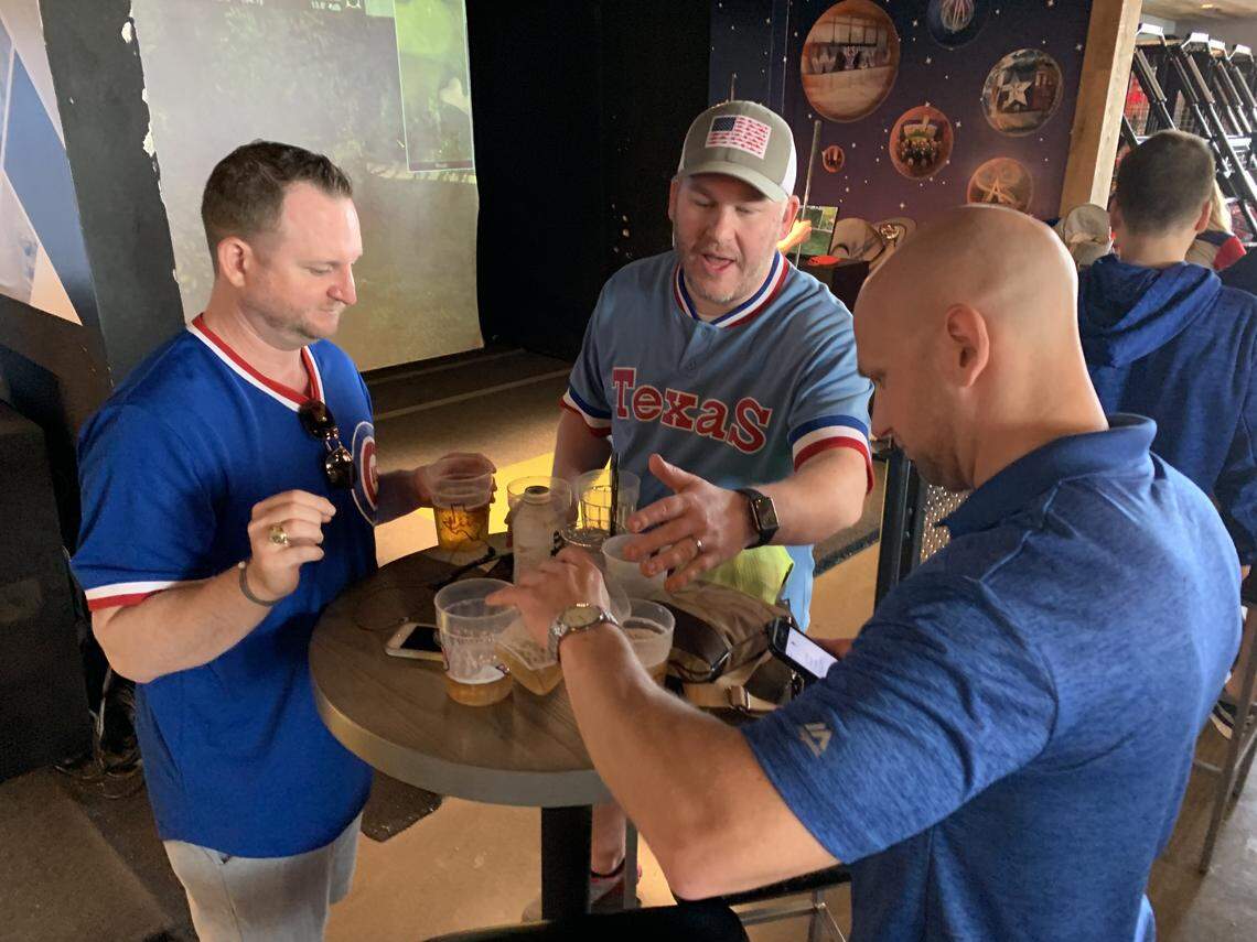 Adam Brown, Charles Grones and Derek Leferink share beer and conversation at Texas Live! on Thursday, the Texas Rangers baseball club’s opening day.
