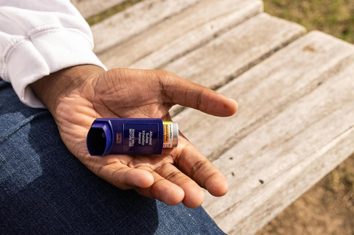 JoSaun Robinson, 14, holds his inhaler, which provides relief when he has an asthma attack.