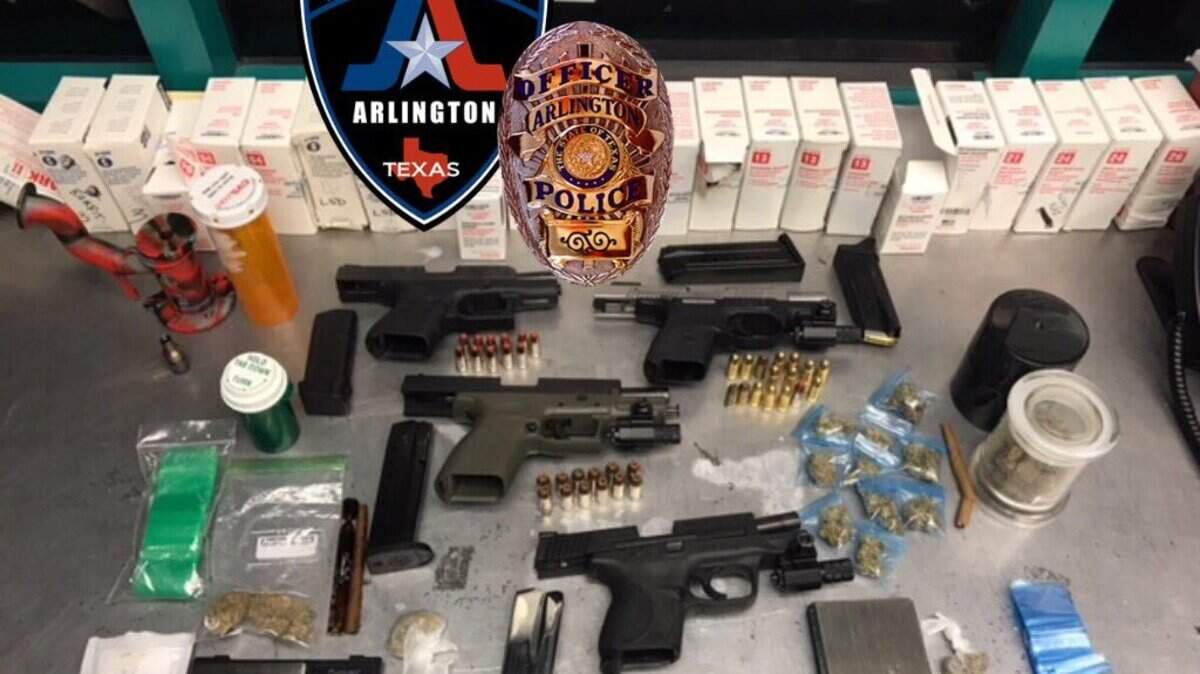 Arlington police seized four guns, one of which was reported stolen, and 30 grams of marijuana in a Saturday traffic stop. The white boxes are drug testing kits, according to a police spokesman.
