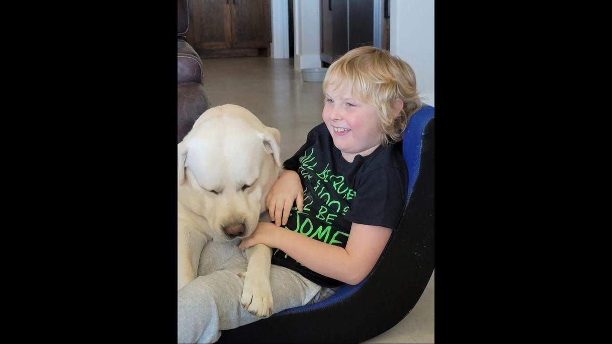 Alex Cornelius, a 10-year-old former Millsap ISD student who is among those investigators say were subjected to abuse by special education educators at Millsap Elementary School, is pictured with his late dog, George.
