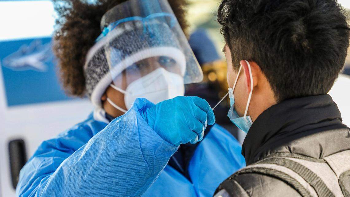 A Mako Medical employee administers a nasal swab COVID-19 test at a pop-up testing location Tuesday, Dec. 21, outside the Transportation Center in Vail, Colorado.
