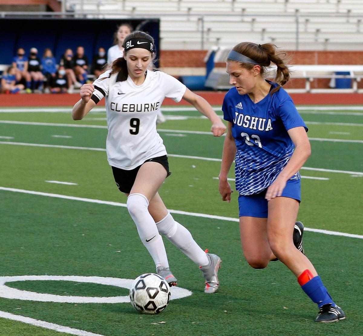 Cleburne’s Tessa Scott (9) and Joshua’s Trinity Grabeal (23) attempt to control the ball during a District 14-5A high school soccer game at Joshua High School in Joshua, Texas, Monday, March 08, 2021. The girls played to a scoreless game. (Special to the Star-Telegram Bob Booth)