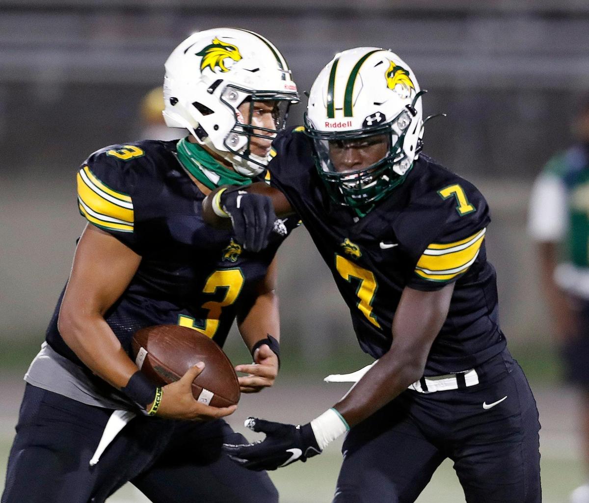 Benbrook quarterback William Green (3) takes the ball back from wide receiver Kennedy Dondreone (7) on a quarterback keeper during a high school football game at Clark Stadium in Fort Worth, Texas, Friday, Sept. 18, 2020. (Special to the Star-Telegram Bob Booth)