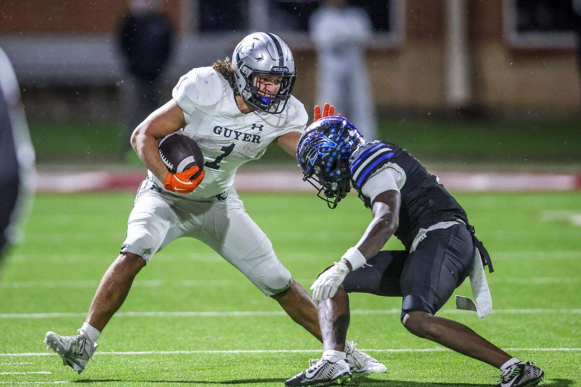 Denton Guyer running back Kaedyn Cobbs uses a stiff-arm to pick up a few more yards against Byron Nelson.