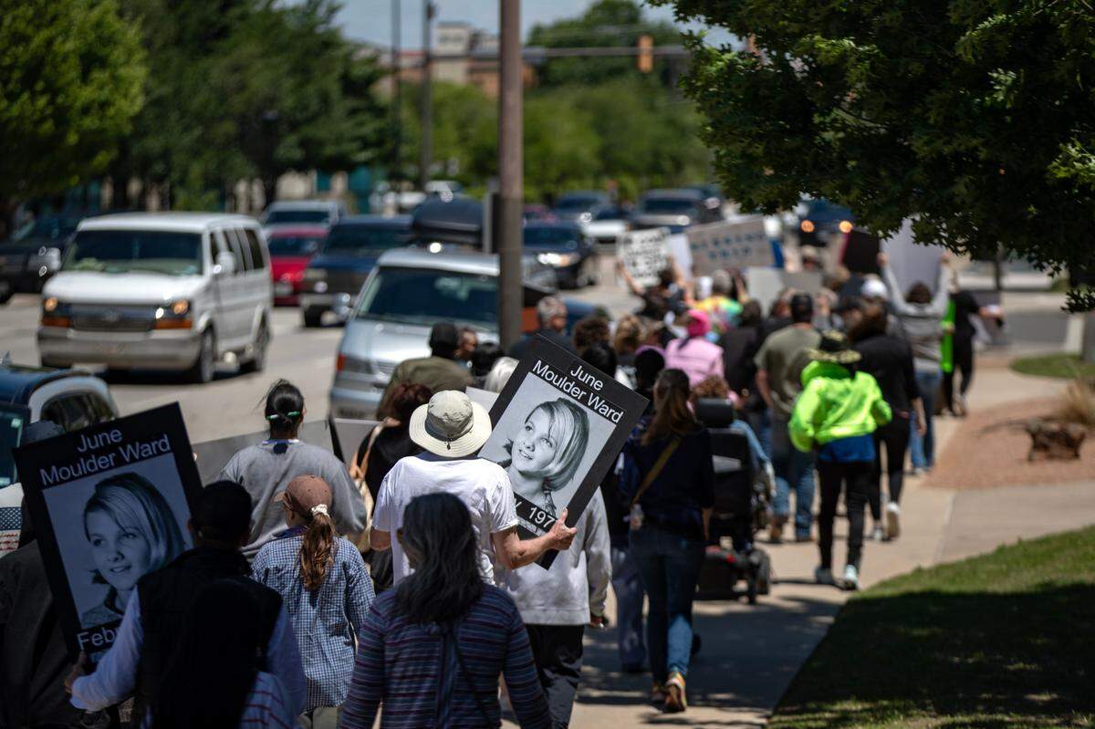 Dozens of people impacted by cold cases gather at the Tarrant County Courthouse in Fort Worth on Saturday, April 29, 2023. They walked downtown to urge local authorities to “thaw the cold cases” and settle unsolved murders, disappearances and crimes.