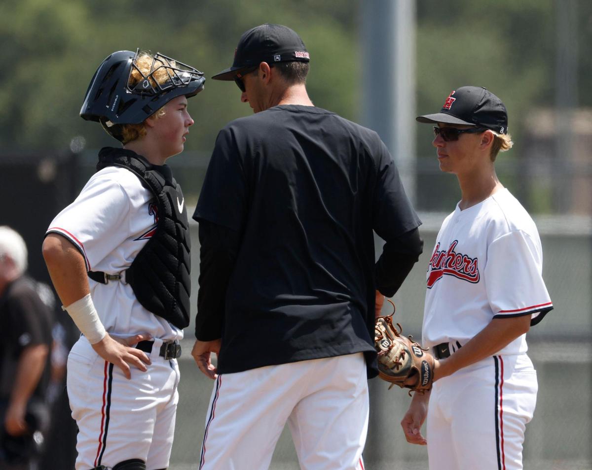 Colleyville Heritage head coach Chris McMullen talks with catcher Logan Rose (13) and pitcher Blake Sibley (7) during the UIL baseball regional final 5A D1 playoff game at Hawk Baseball Field in North Richland Hills, Texas, Thursday, May 22, 2025.