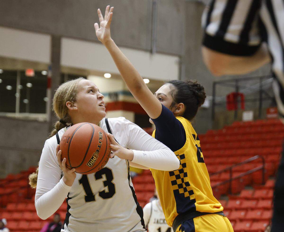 Cleburne forward Arrisa Turner (13) gets a look defended by Arlington Heights guard Brooklynn Gold (22) during the first half of the UIL 5A D1 girls bi-district championship basketball game at Wilkerson Greines Activity Center in Fort Worth, Texas, Monday Feb. 16, 2026.