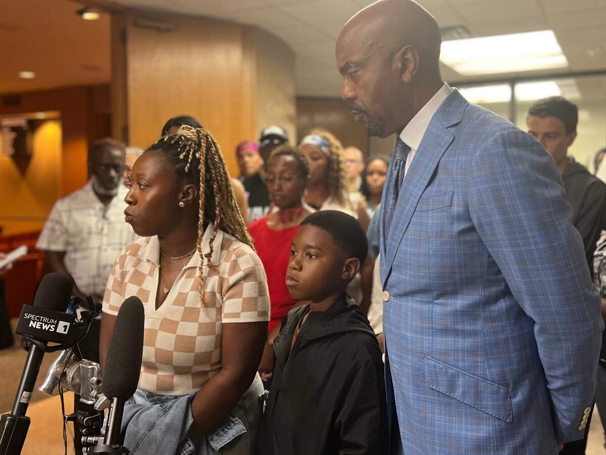 Janell Johnson, left, stands with her 10-year-old son Corbin and the family’s attorney, Daryl Washington, surrounded by other family members as they speak to reporters outside of Tarrant County Commissioners Court on June 2. It was the first time the family had spoken out since two jailers were indicted on murder charges in connection with the death of Anthony Johnson Jr. in the Tarrant County Jail.
