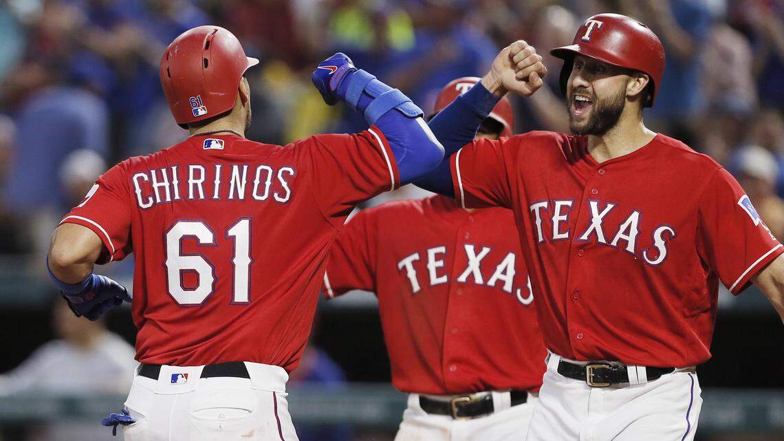 Texas Rangers’ Robinson Chirinos (61) is congratulated by Joey Gallo, right, after hitting a three-run home run during the fourth inning against the Arizona Diamondbacks, Monday, Aug. 13, 2018, in Arlington.