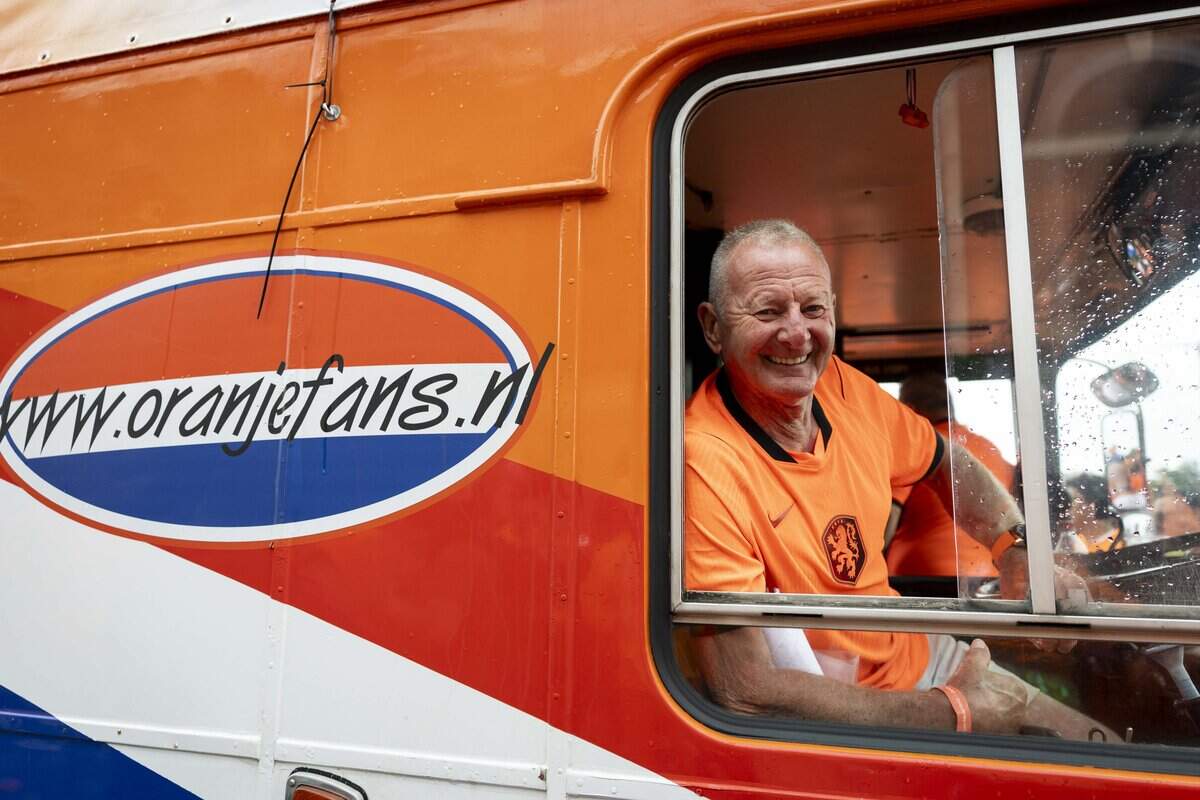 Frans Peeters the driver of the orange bus prepares to lead the march to Dallas Stadium ahead of the FIFA World Cup match against Japan on Sunday, June 14, 2026 in Arlington, Texas. The famous double-decker Dutch Orange Bus, or De beroemde Oranjebus, is part of a Netherlands fan tradition bringing a sea of orange to the streets before major soccer matches.