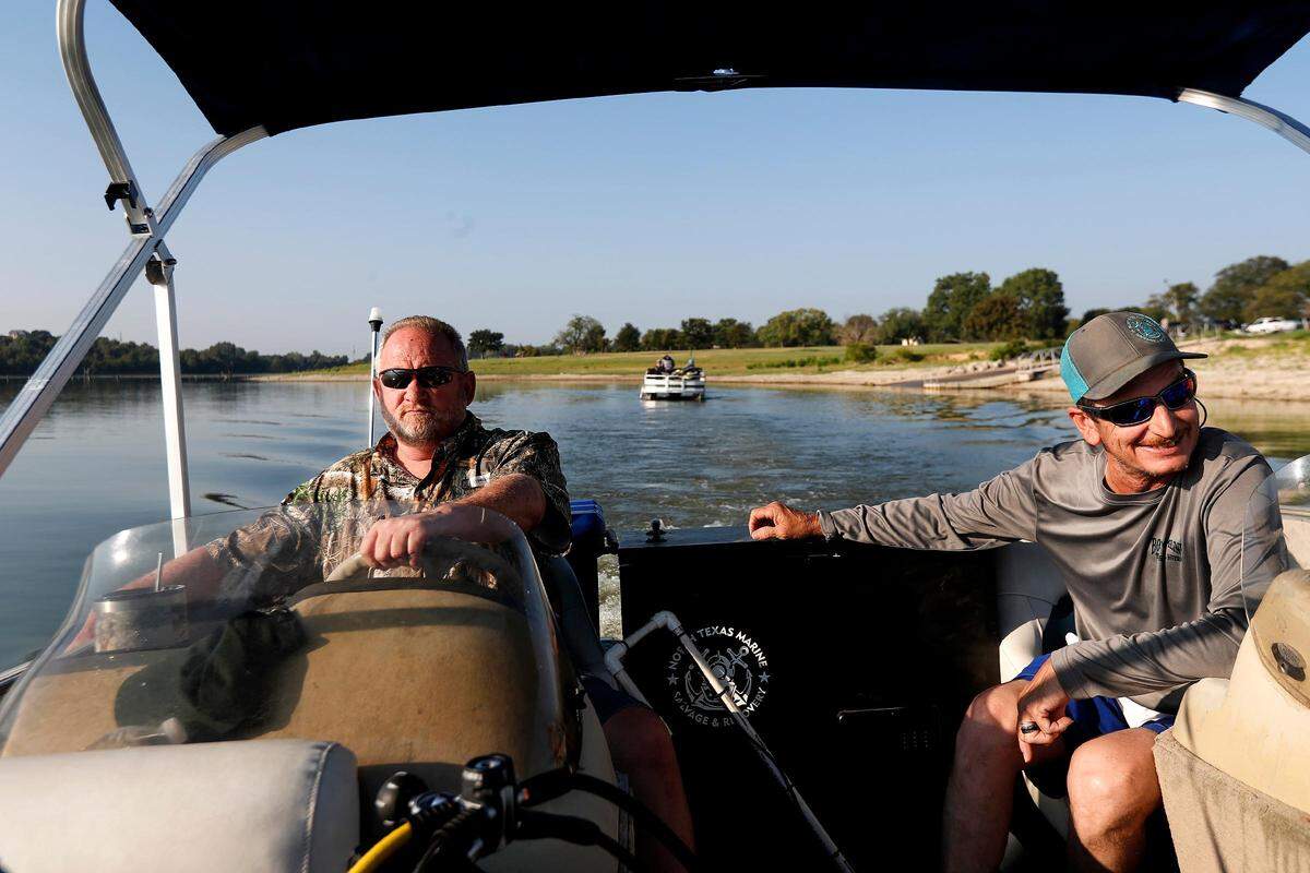 Rusty Arnold, left, and Jason Burns head towards the location of the third and final submerged car in Benbrook Lake on Monday, September 16, 2019. For years Arnold has been searching for his sister, Rachel Trlica, who went missing in 1974. With the help of North Texas Marine Salvage & Recovery’s dive team, he has raised two of the cars to check if they were connected to his sister’s disappearance.