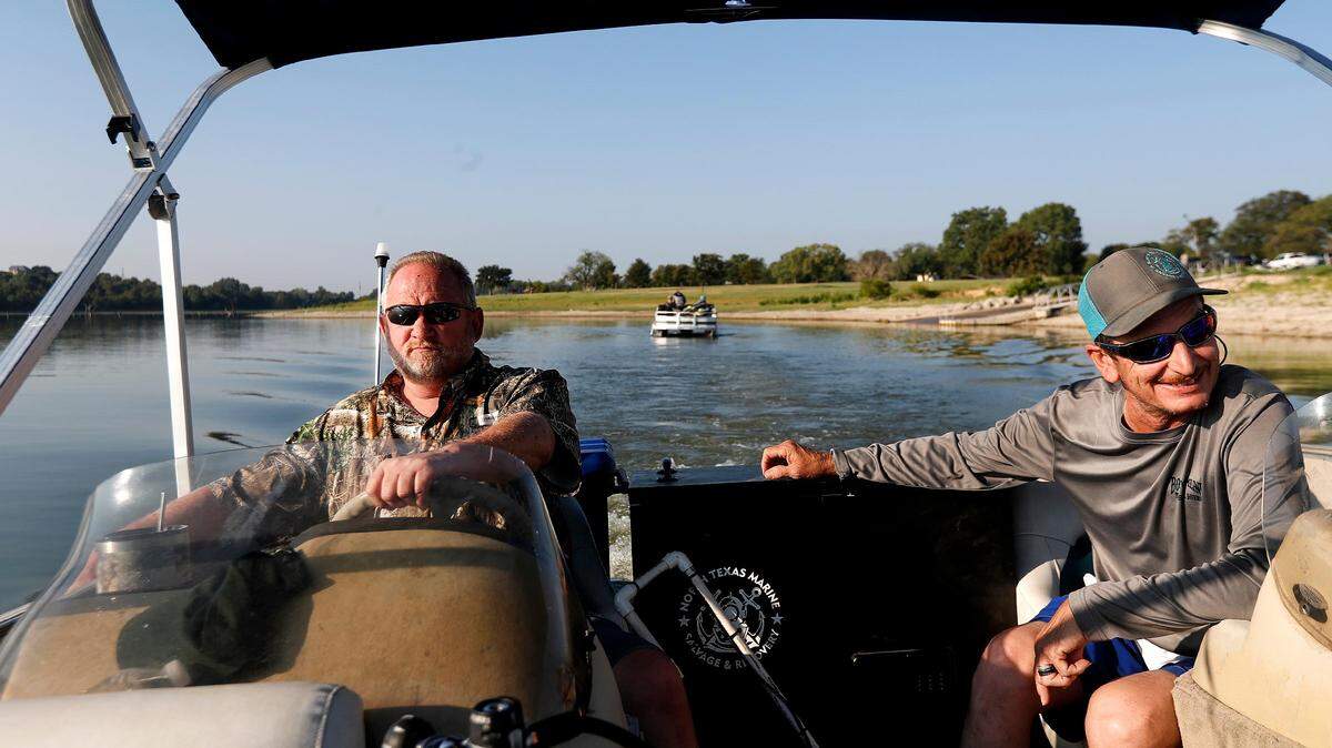 Rusty Arnold, left, and Jason Burns searched for cars in Benbrook Lake in 2019 in hopes of finding answers to the 1974 disappearance of his sister.