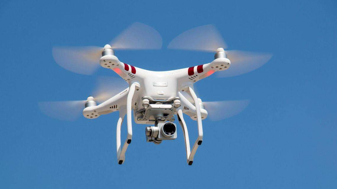 Drone with a camera hovering in the air.