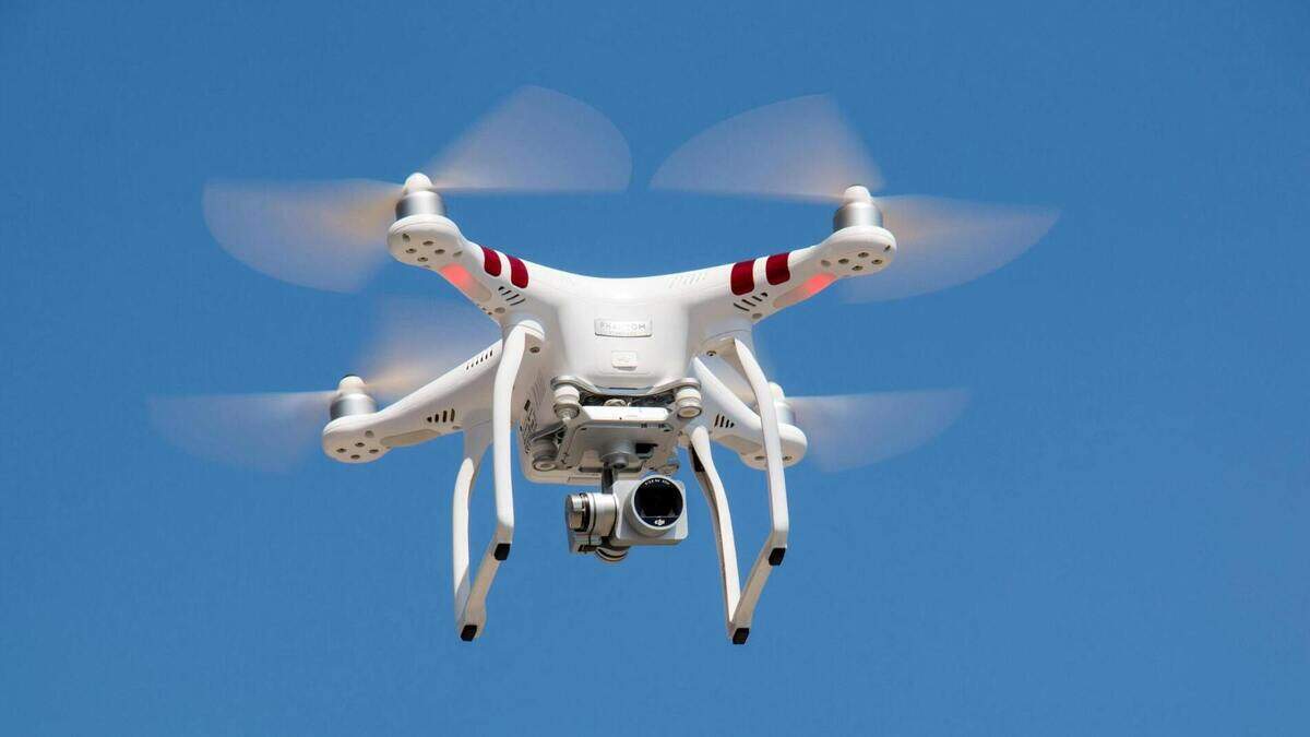 Drone with a camera hovering in the air.