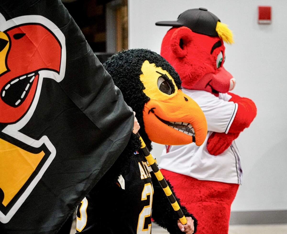 Rowdie Bear, the Indianapolis Indians’ mascot, helps a student learn moves during a mascot camp in Avon, Indiana. Mascots would be exemoted from a proposed Texas law that would ban students from wearing costumes.