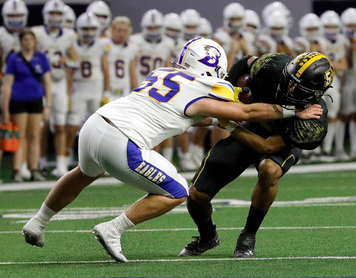 Brock lineman Hyatt Dunaway (55) drops Malakoff running back Damien Jackson (5) for a loss in the first half of a UIL Class 3A D1 state semifinal football game at the Ford Center in Frisco, Texas, Thursday, Dec. 08, 2022. Brock led Malakoff 14-3 at the half. (Special to the Star-Telegram Bob Booth)