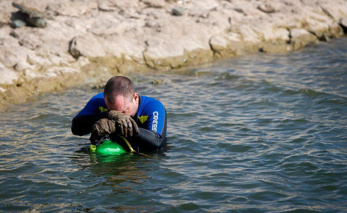 Diver Jeff Burns rests on the shore of Benbrook Lake after having to abort the mission to locate the third and final car located at the bottom of the lake on Monday, September 16, 2019. The car was so deteriorated that it crumbled and broke apart while attempting to raise it, making it dangerous for the divers.