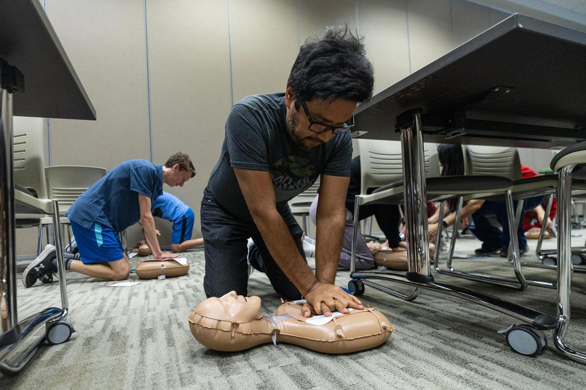 Jose Perez practices how to do chest compressions during a CPR class at the Pat May Center in Bedford on Tuesday, Oct. 29, 2024.