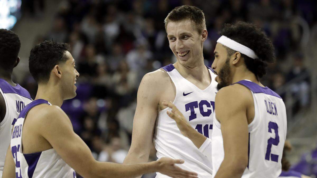 TCU's Alex Robinson, left, Vladimir Brodziansky (10) of Slovakia and Shawn Olden (2) celebrate a recent game.  TCU fought off a slow start Saturday against Oklahoma State to win the Big 12 Conference game with ease.