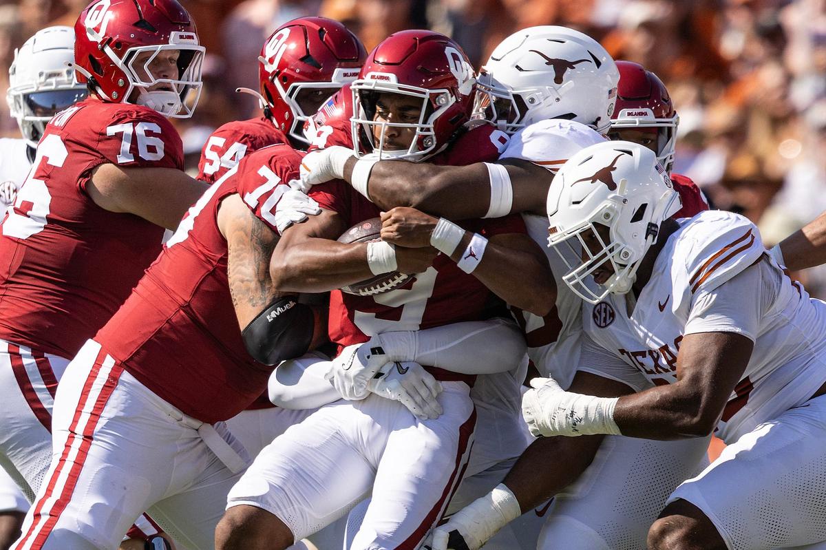 Oklahoma quarterback Michael Hawkins Jr. (9) is sacked by the Texas defense in the first half of an NCAA football game at the Cotton Bowl in Dallas on Saturday, Oct. 12, 2024.