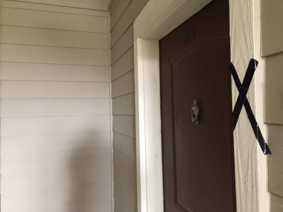 Black tape marked residents’ doors where the SWAT team had marked them.
