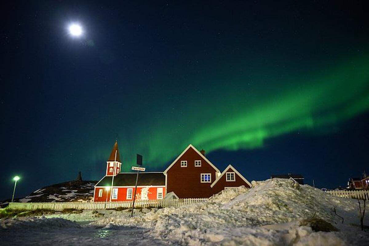TOPSHOT - Northern lights (Aurora Borealis) glow above a small church in the city of Nuuk, Greenland on January 28, 2026. (Photo by Ina FASSBENDER / AFP via Getty Images)