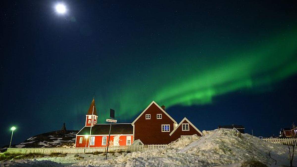 TOPSHOT - Northern lights (Aurora Borealis) glow above a small church in the city of Nuuk, Greenland on January 28, 2026. (Photo by Ina FASSBENDER / AFP via Getty Images)