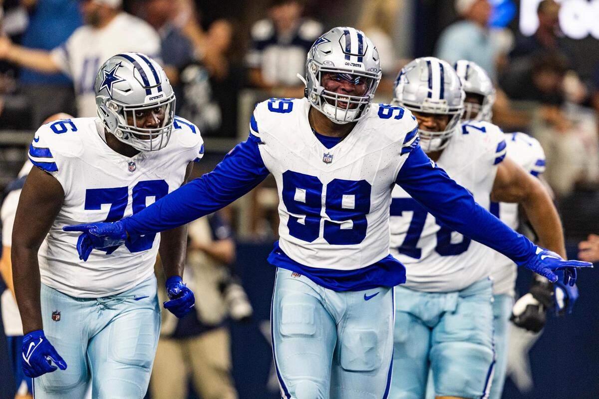 Cowboys defensive end Chauncey Golston (99) celebrates after scoring a two-point conversion against the New England Patriots at AT&T Stadium in Arlington on Sunday, Oct. 1, 2023.